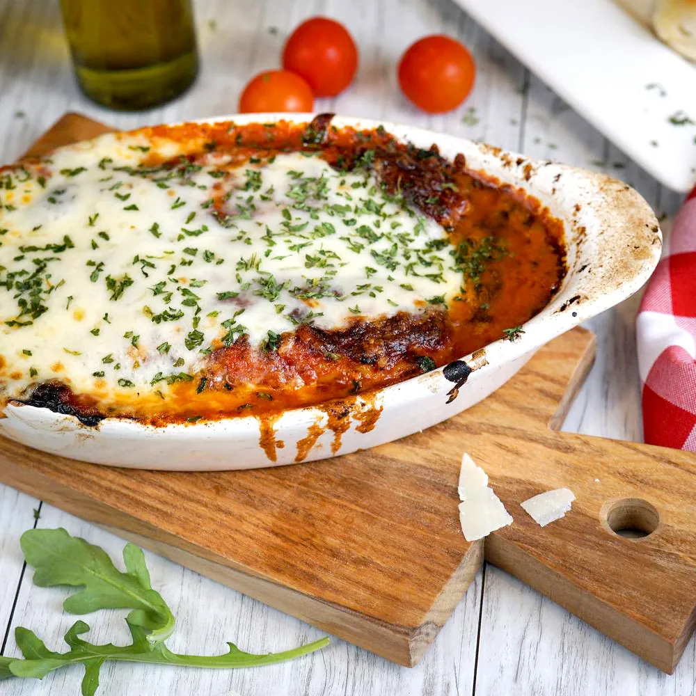 Baked lasagna in an oval gratin dish