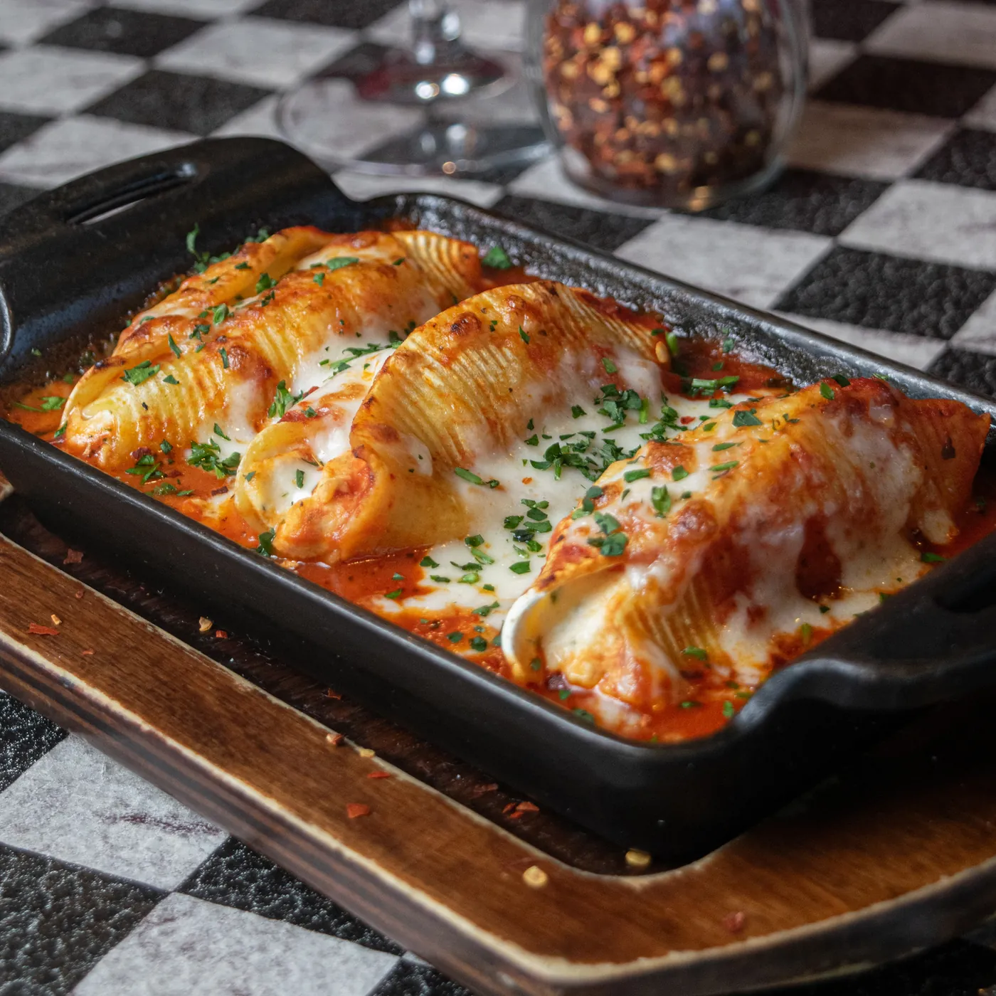 Stuffed pasta shells baked in red sauce with mozzarella