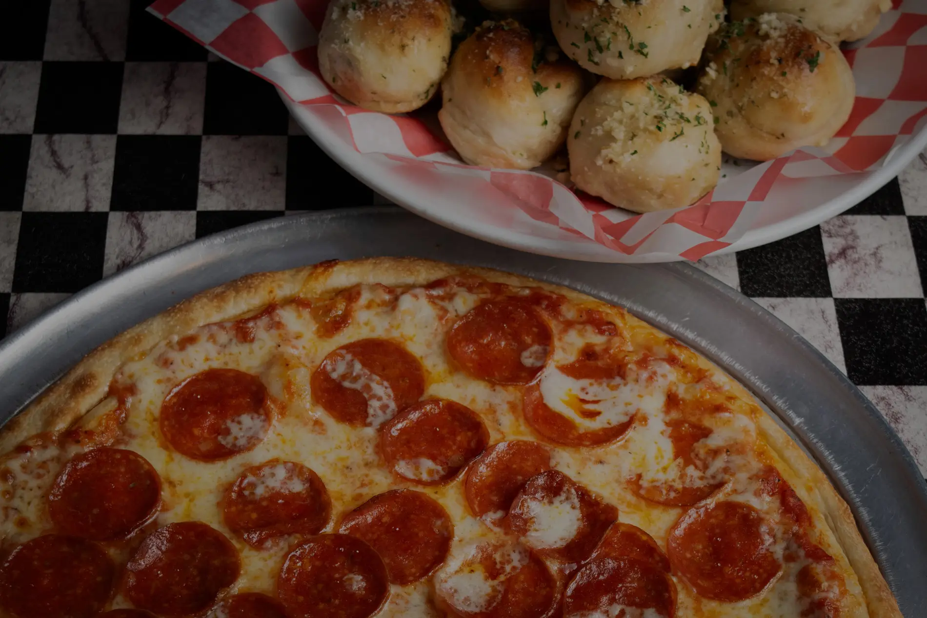 Pepperoni pizza and garlic knots at Di Papa's